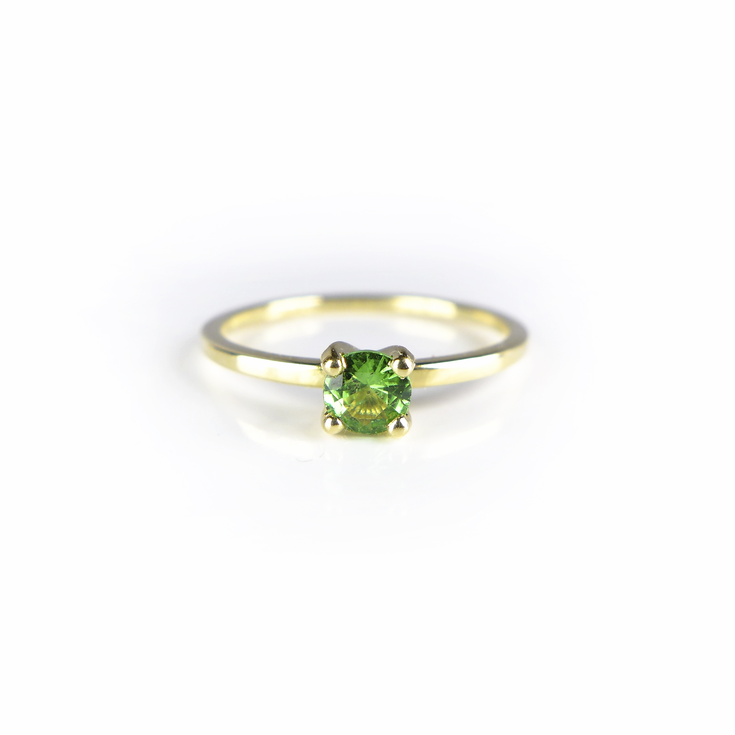 golden ring with a green stone